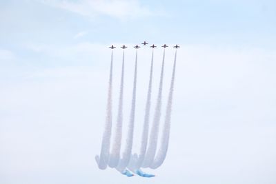 Low angle view of airplane flying against sky