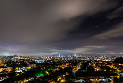 High angle view of illuminated cityscape against sky at night