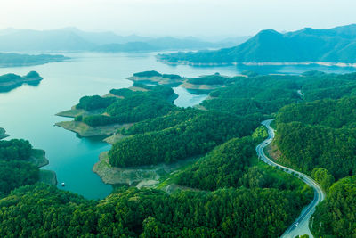 High angle view of sea and mountains against sky