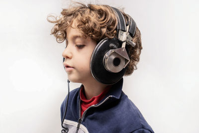 Portrait of boy wearing mask against white background