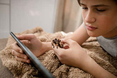 Side view of young woman using mobile phone