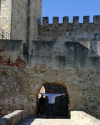 Rear view of people standing in front of building