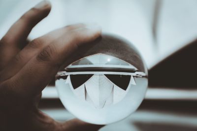 Close-up of hand holding crystal ball