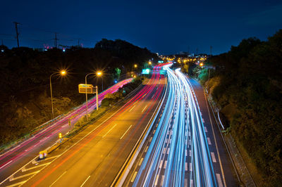 High angle view of light trails on road at night