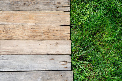 High angle view of wooden plank on field