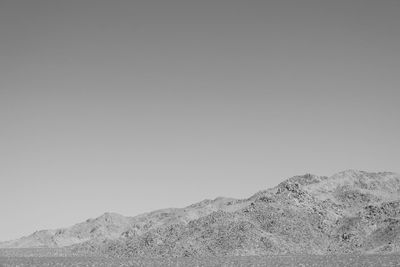 Scenic view of arid landscape against clear sky