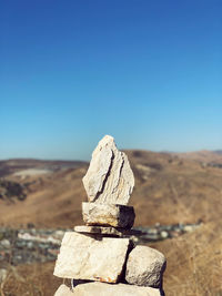 Rocks stacked against clear sky