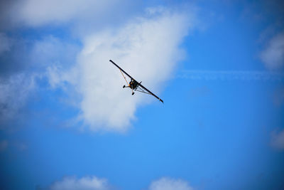 Low angle view of airplane flying in sky