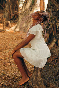 Side view of woman wearing hat