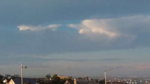 Cityscape against cloudy sky