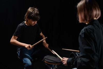 Musicians playing drums in dark