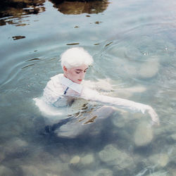 High angle view of boy swimming in pool