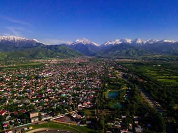 High angle view of townscape and mountains against sky