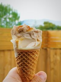 Close-up of hand holding ice cream cone