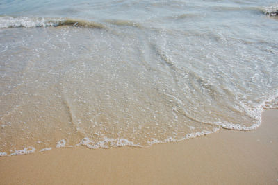 High angle view of waves rushing towards shore