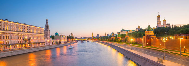 View of illuminated buildings against sky in city