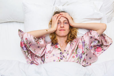 Portrait of woman lying down on bed