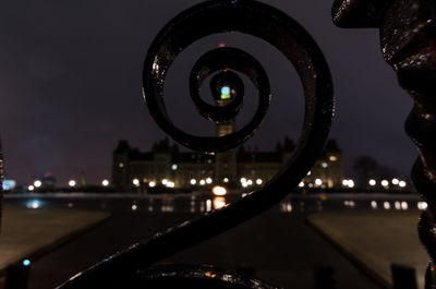 Close-up of illuminated cityscape against sky at night