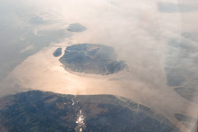 Aerial view of island during foggy weather