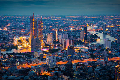 High angle view of city lit up at dusk