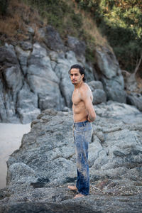 Young man standing on rock