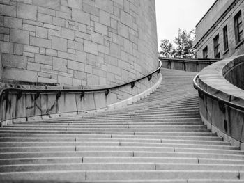 Low angle view of empty steps by wall