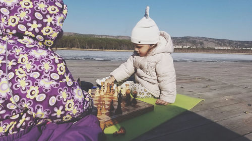 Two baby girls playing chess