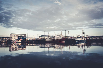 Pier on harbor against sky