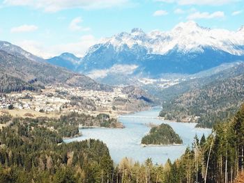 Scenic view of river against mountains and sky on sunny day