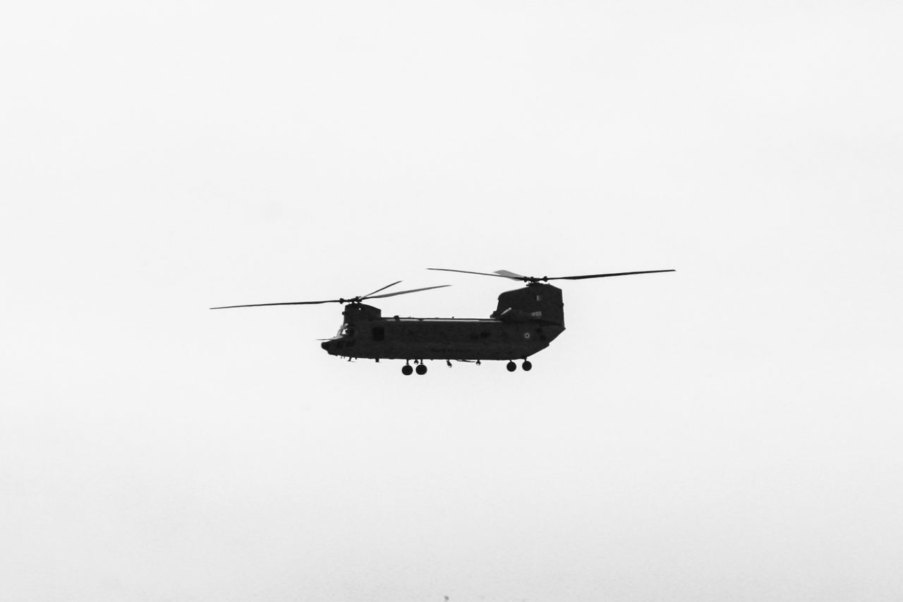 LOW ANGLE VIEW OF HELICOPTER IN SKY