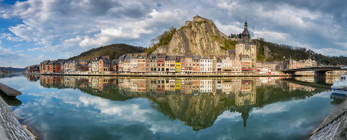 Scenic view of lake by buildings against sky