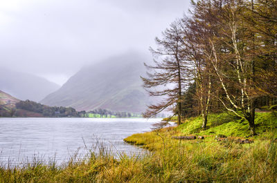 Scenic view of lake and mountains against sky