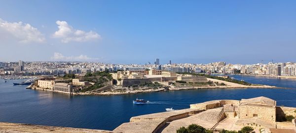 High angle view of townscape by sea against sky