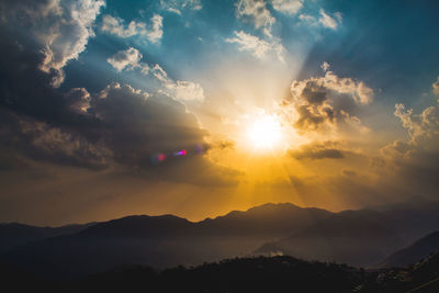 Scenic view of silhouette mountains against sky during sunset