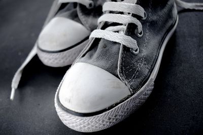 Low section of person wearing leather shoes
