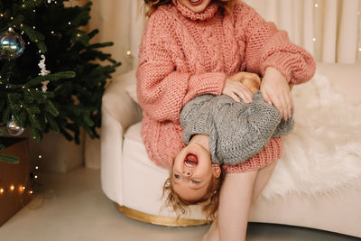 Midsection of woman holding christmas tree