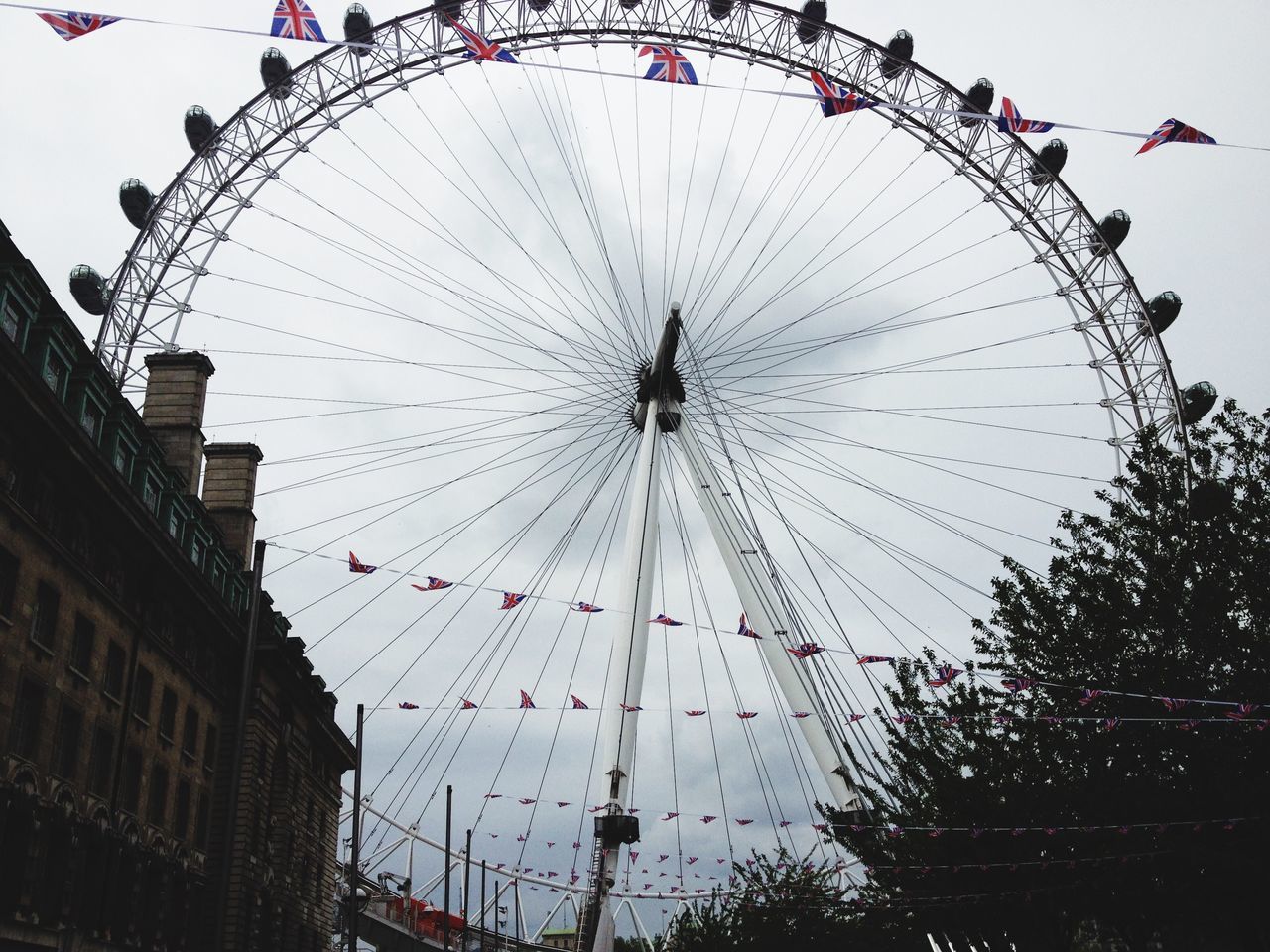 amusement park, amusement park ride, ferris wheel, arts culture and entertainment, low angle view, sky, chain swing ride, built structure, architecture, fun, enjoyment, big wheel, traveling carnival, travel destinations, clear sky, fairground ride, leisure activity, fairground, outdoors, building exterior