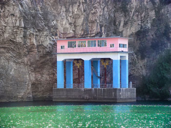 View of building with reflection of trees in lake