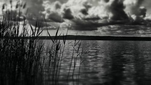 Scenic view of lake against cloudy sky