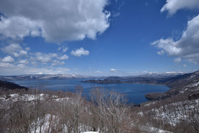 Panoramic view of sea and snowcapped mountains against sky