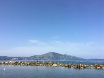 Scenic view of sea against blue sky