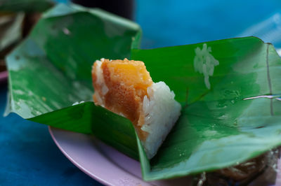 Glutinous rice steamed in banana leaf, bananas and sticky rice inside. a traditional thai food style