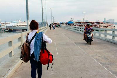 Rear view of women walking on street in city