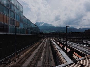 Railroad track against cloudy sky