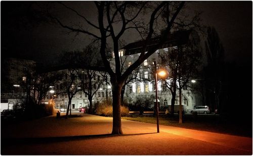 Road passing through city at night