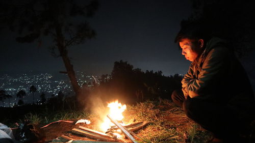 Man and bonfire at night