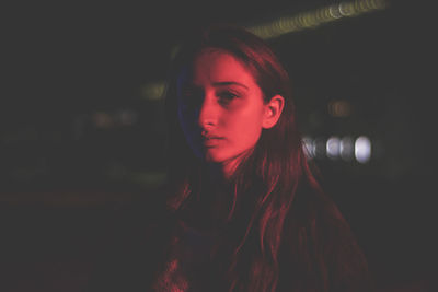 Portrait of teenage girl in red light