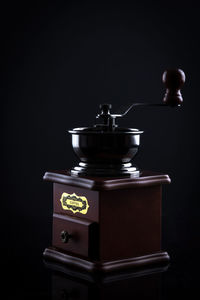 Close-up of tea cup on table against black background