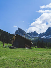 Scenic view of field and mountains against sky