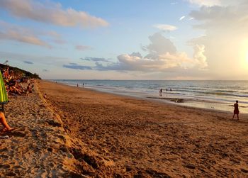 Scenic view of beach against sky during sunset